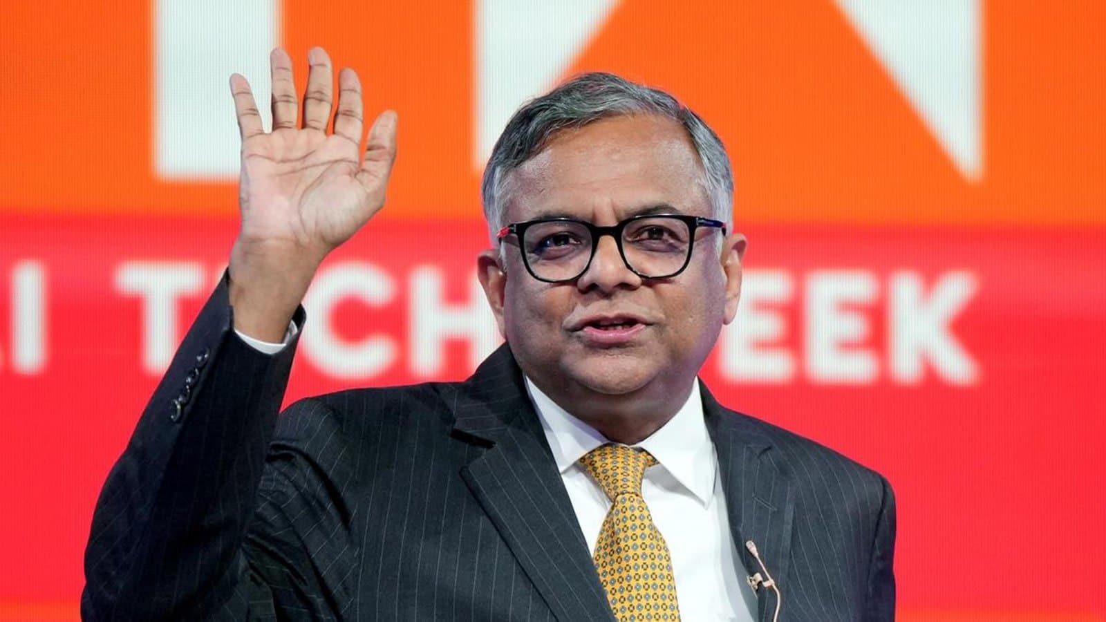 N. Chandrasekaran raising a hand while speaking on stage at a technology conference. File photograph. फाइल फोटो।