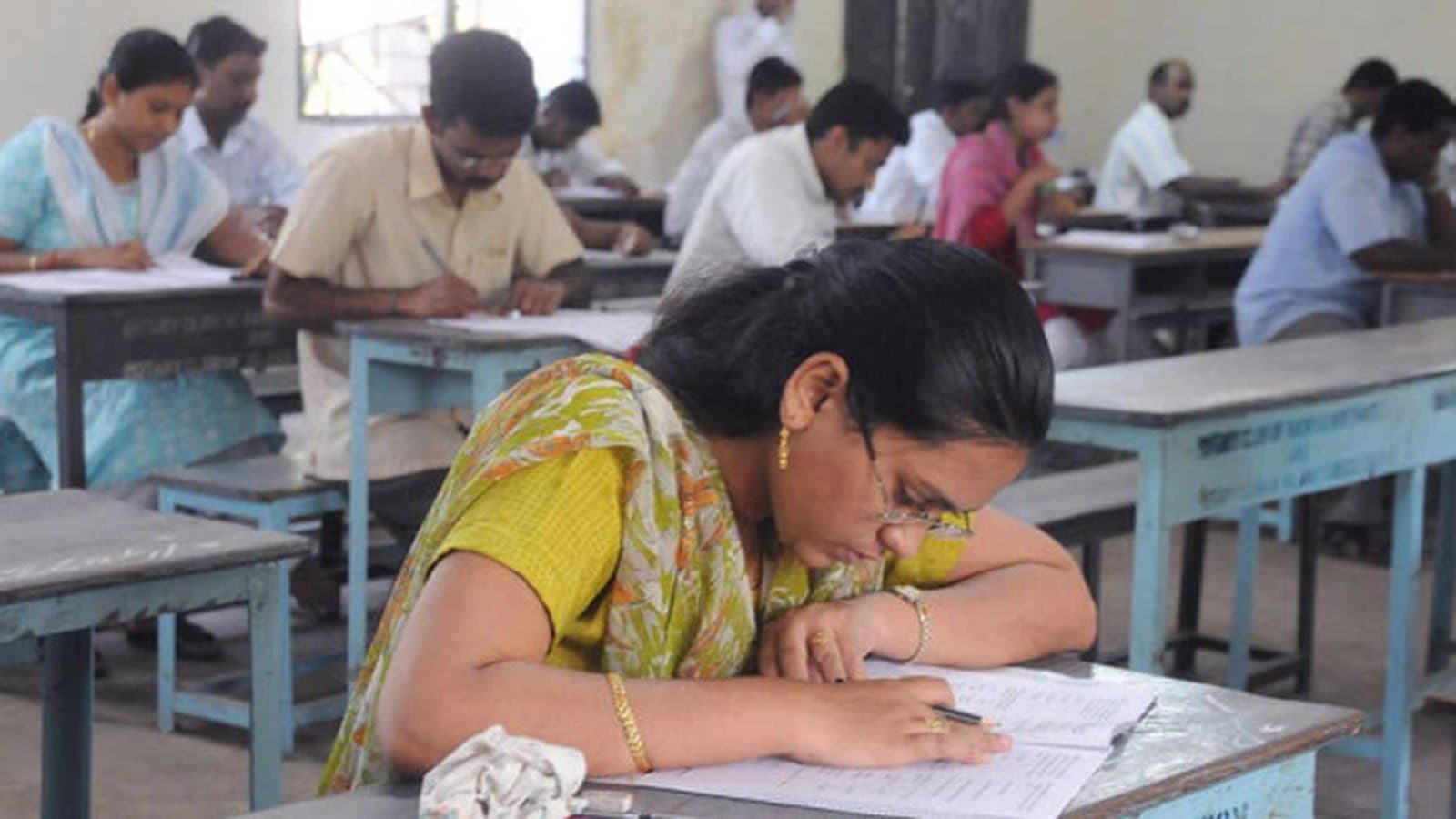 Candidates seated at desks in a classroom writing a competitive examination. File photograph. फाइल फोटो।