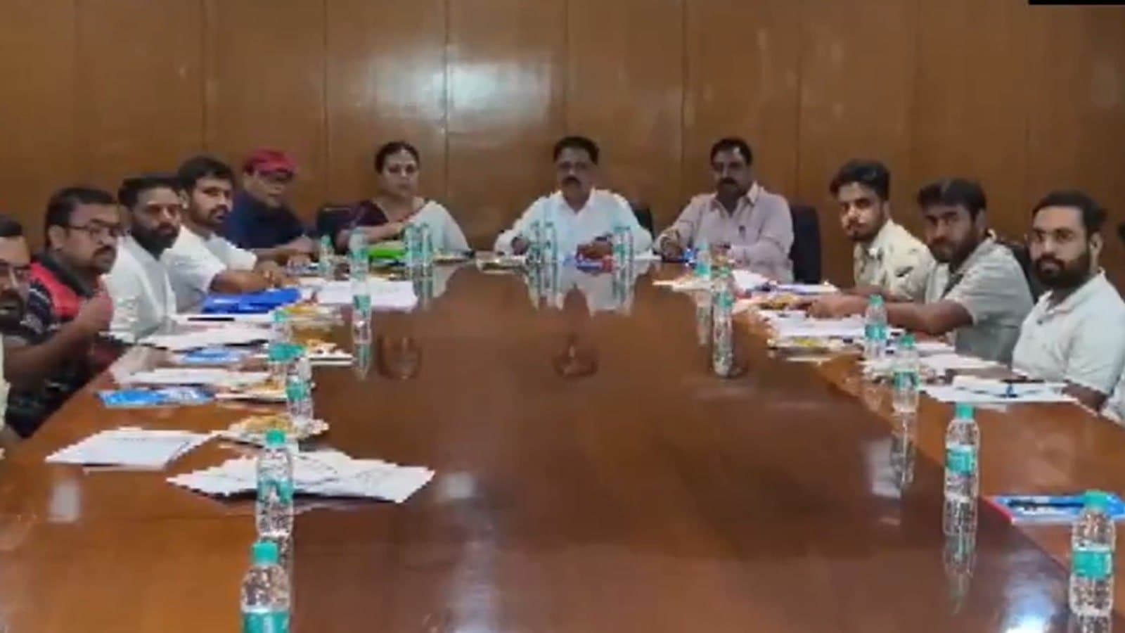 Officials and student representatives seated on either side of a long conference table during talks in Ranchi.
