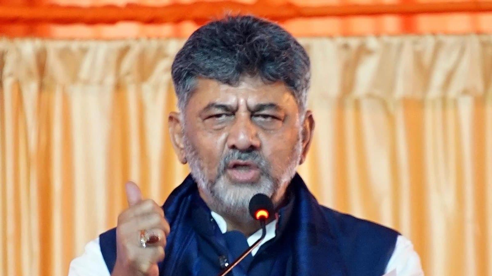 Karnataka Chief Minister D.K. Shivakumar speaking at a microphone, gesturing with one hand. File photograph.
