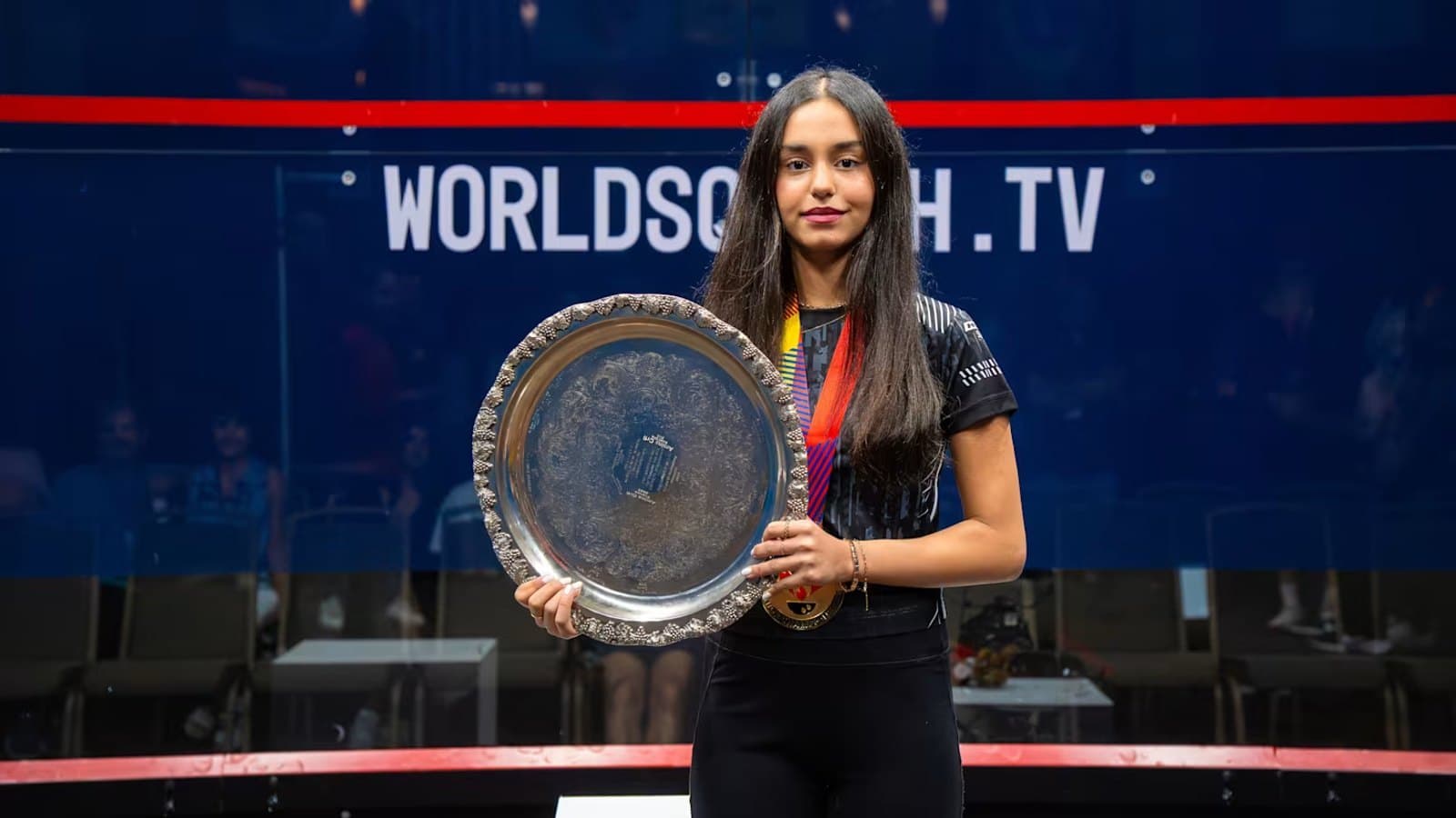 Anahat Singh holding the championship salver on court after the World Squash Junior Championships final.
