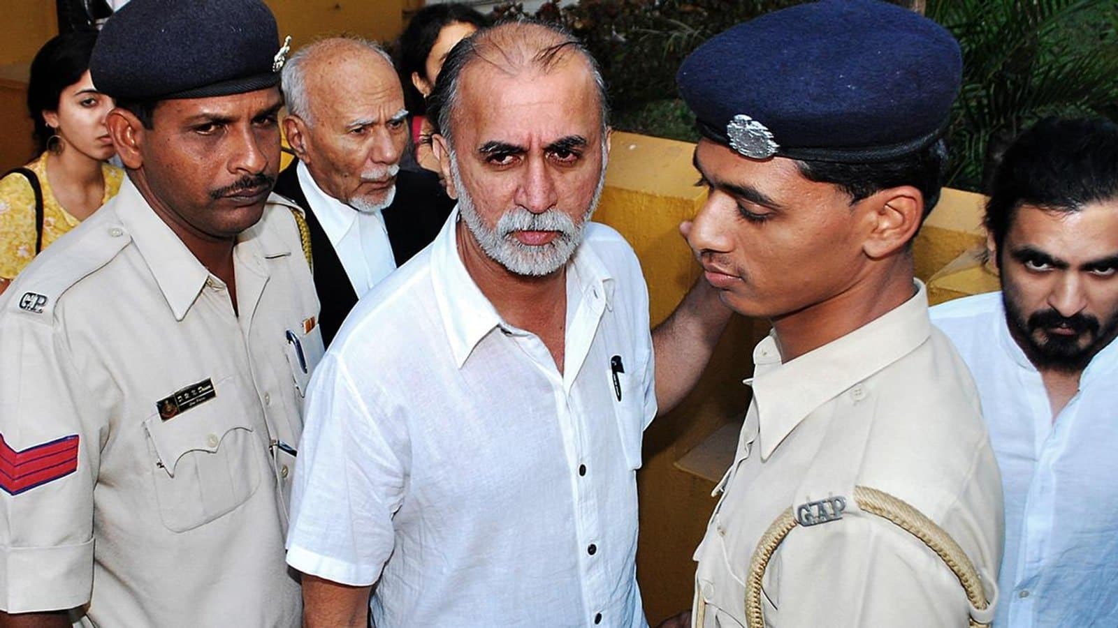 Tarun Tejpal escorted by Goa police officers through a crowd outside court. File photograph.