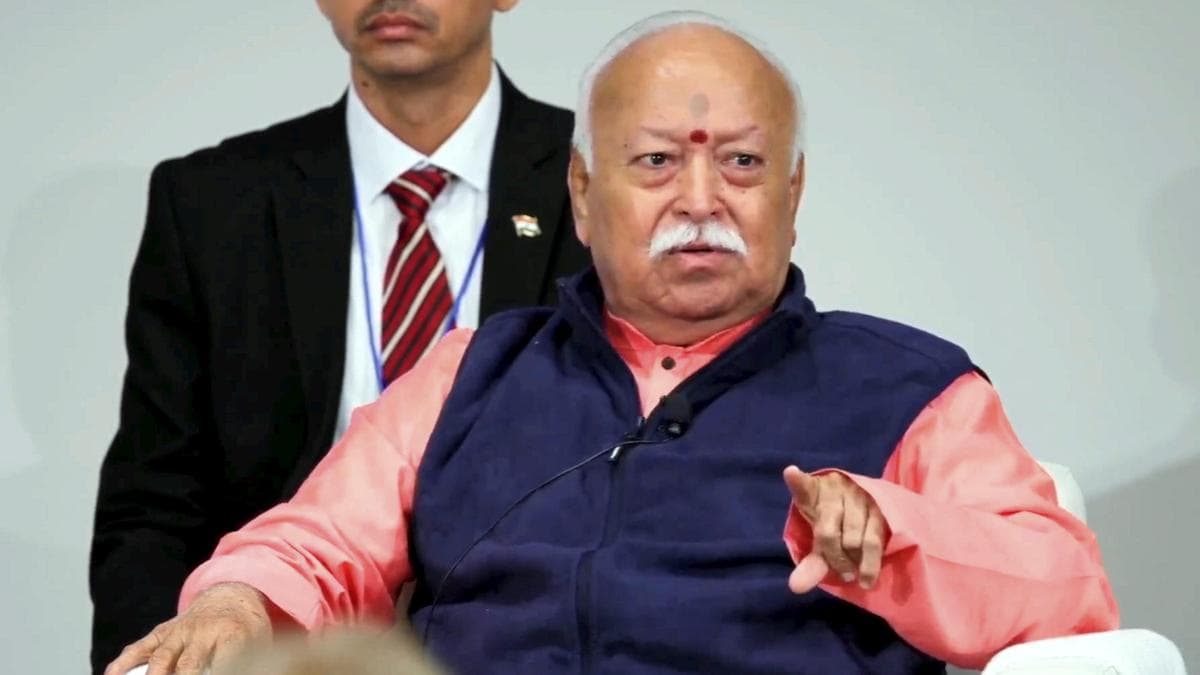 RSS chief Mohan Bhagwat gestures while speaking at a public event