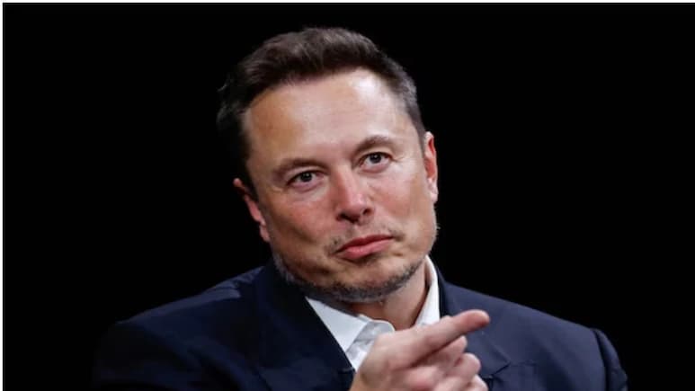 Elon Musk gestures while speaking at an event