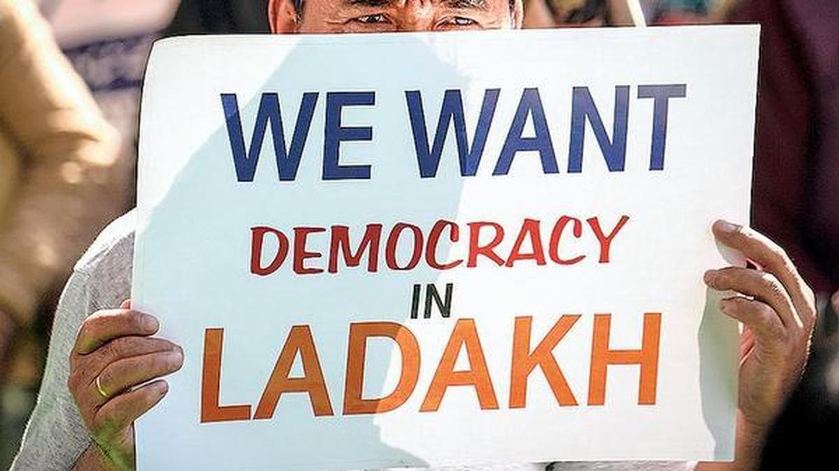 A protester holds a placard reading We Want Democracy In Ladakh during a demonstration