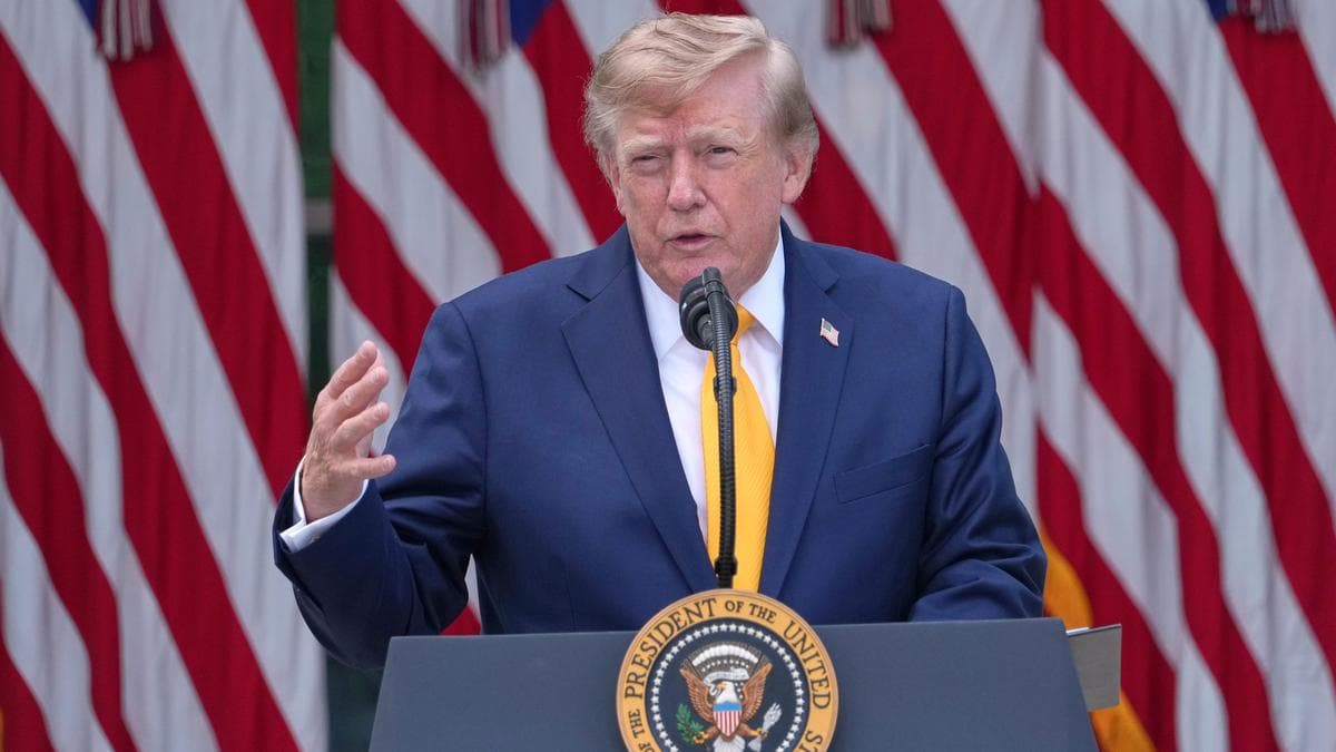 US President Donald Trump speaks at a podium in front of American flags